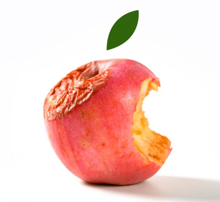 A rotten red apple with a bite